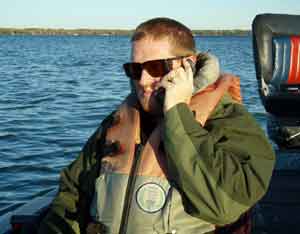 Dan Kimmel talks to bender on the phone before starting to fish for the day.