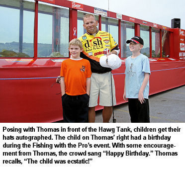 Posing with Thomas in front of the Hawg Tank, children get their hats autographed. The child on Thomas’ right had a birthday during the Fishing with the Pro’s event. With some encouragement from Thomas, the crowd sang “Happy Birthday.” Thomas recalls, “The child was ecstatic!”