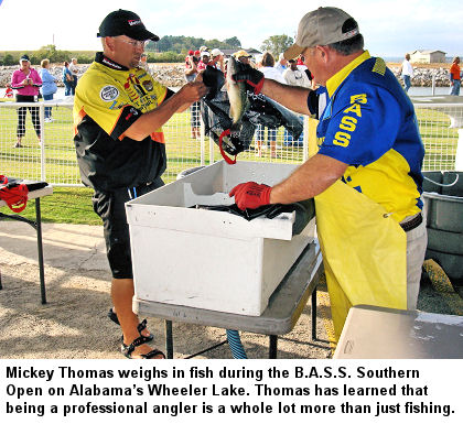 Mickey Thomas weighs in fish during the B.A.S.S. Southern Open on Alabama's Wheeler Lake. Thomas has learned that being a professional angler is a whole lot more than just fishing.