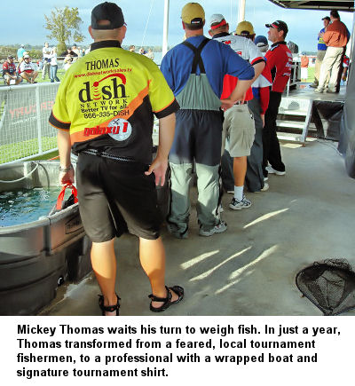 Mickey Thomas waits his turn to weigh fish. In just a year, Thomas transformed from a feared, local tournament fisherman, to a professional with a wrapped boat and signature tournament shirt.