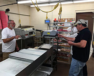 Bruce Kraemer looks on (L) as they check the certified scales on September 12, 2016 before weighing his big smallmouth bass.