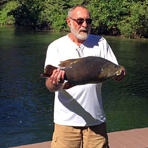 Bruce Kraemer caught this giant 9.98 pounds Michigan smallmouth bass fishing from shore on the Indian River with a live nightcrawler on a three-way rig.