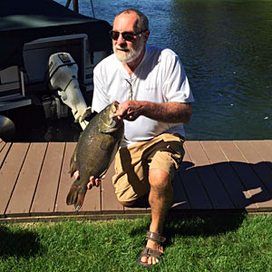 Bruce Kraemer shows his monster toad 9.98 pounds smallmouth bass he caught on a nightcrawler from Michigan's Indian River on September 11, 2016.