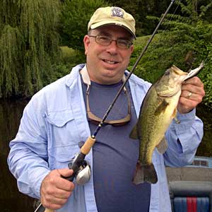 Mark cameraguy Gomez with his biggest largemouth bass of the day from the Grand River in Lansing