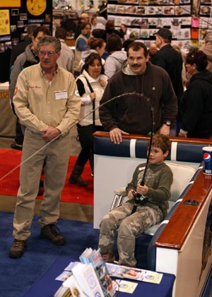 Outdoorama is a family-fun show. This youngster battles a big salmon on the Virtual Fishing Simulator.