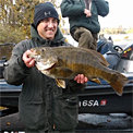 Michigan bass tournament angler Greg Gasiciel shows his record-sized 9.32 pounds smallmouth bass he caught fishing the Hubbard Lake Open. Photo credit: Bill McQuarrie