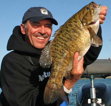 Louie’s largest smallmouth to date is a 6-14 beast taken from Burt Lake in Northern Michigan. He caught it on a Strike King tube in 3’ of water in the fall of 2008.