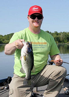 Chunky largemouth bass caught by Dan Kimmel along a deeper inside weed line casting a black and blue bladed jig with a trailer.