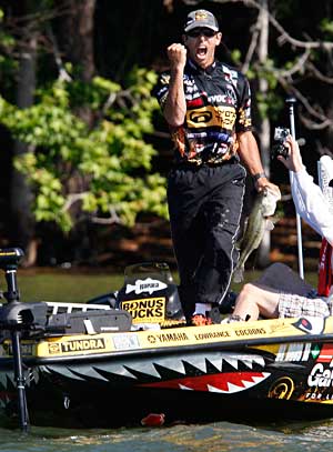 Professional angler Michael Iaconelli pumps his fist in the air after landing another nice bass during a 2011 Elite Series event