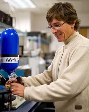 NOAA's Patricia Lang prepares to measure methane levels inside a flask as part of the global air sampling network