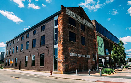 The Outdoor Adventure Center is housed in what was the Globe Building. Much of the historical integrity of the building was maintained during construction, including walls of original brick, cast iron and Wellman trusses.