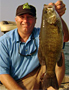 Captain Wayne Carpenter shows one of many big smallmouth bass he has caught from Lake St. Clair