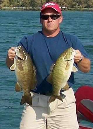 Derek Baetz with a couple big Northern Michigan smallmouth bass from Mullett Lake.
