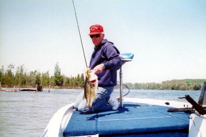 Larry Dekker hefts a Clam Lake Hog Largemouth Bass