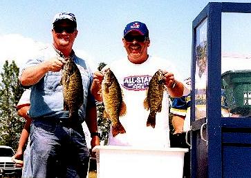 Weighmaster John Maniaci helps me hold up some of our Saginaw Bay limit of smallies.