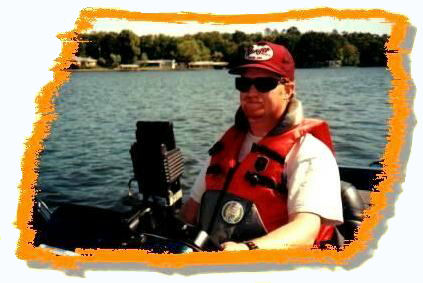Dan Kimmel wears his life jacket and checks out his GPS while boating in his bass boat.