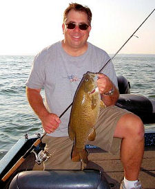 Mark 'cameraguy' Gomez with a big smallmouth bass he caught on a tube while taking a break from taping bass fishing video action!