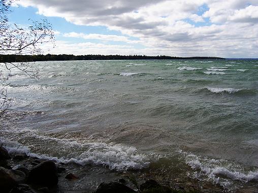 The wind howls pounding big waves into the beach at Aloha State Park on Mullett Lake.
