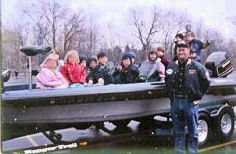 Young seminar students sit for a photo in Dan Kimmel's boat