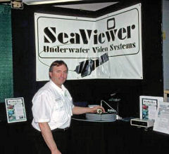 Wayne Carpenter demonstrates Seaviewer underwater cameras at his show booth